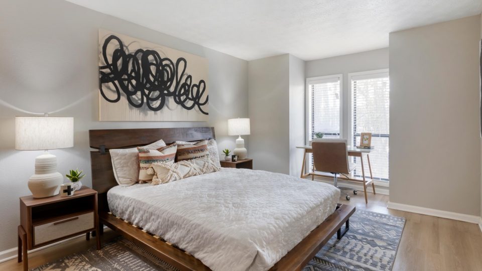 a bedroom with a bed, nightstands and a painting at The The Breck