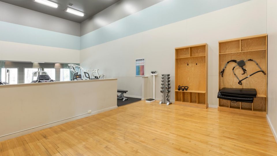 a gym room with a bench and exercise equipment at The The Breck
