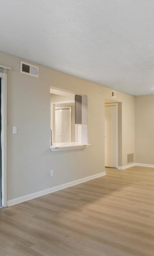 empty room with sliding glass doors and hardwood floors at The The Breck