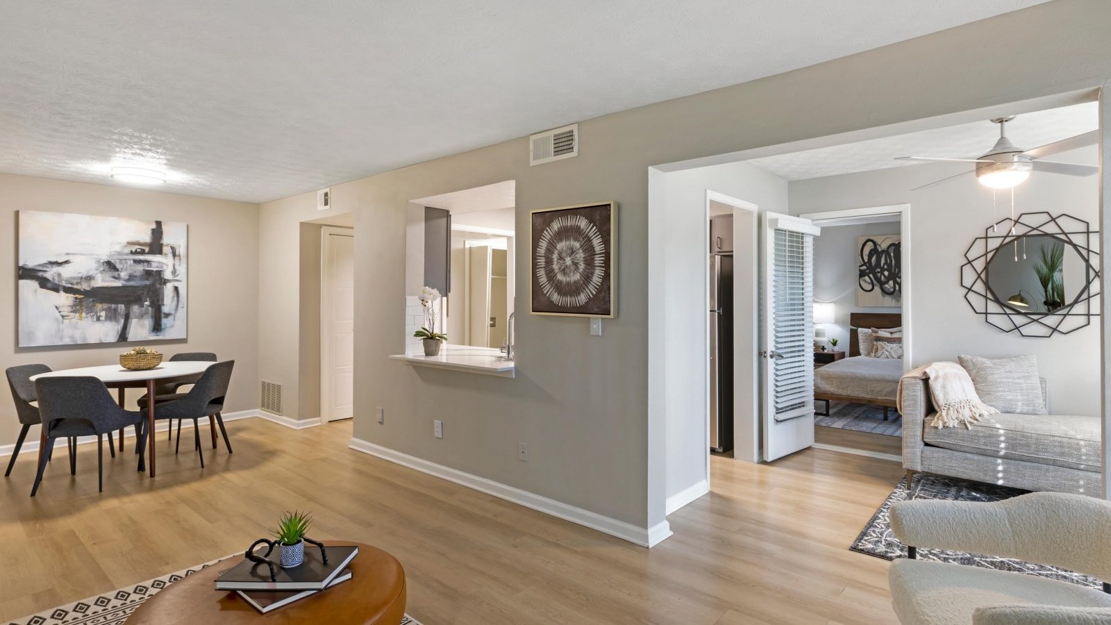 a living room with hardwood floors and a dining area at The  Breck