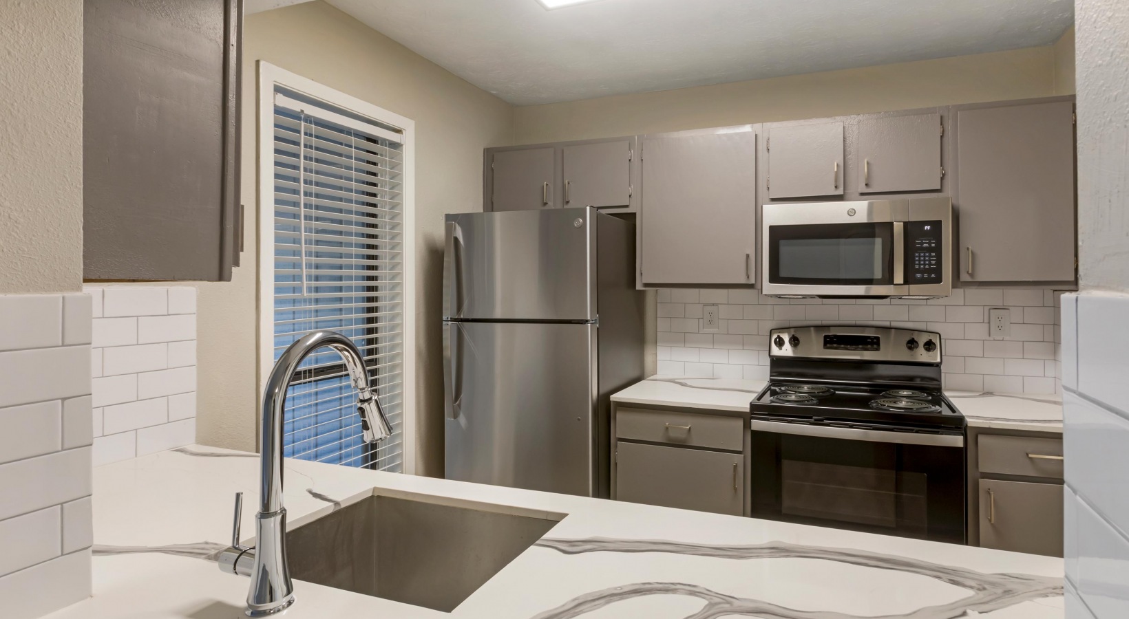 a kitchen with stainless steel appliances and a microwave at The The Breck