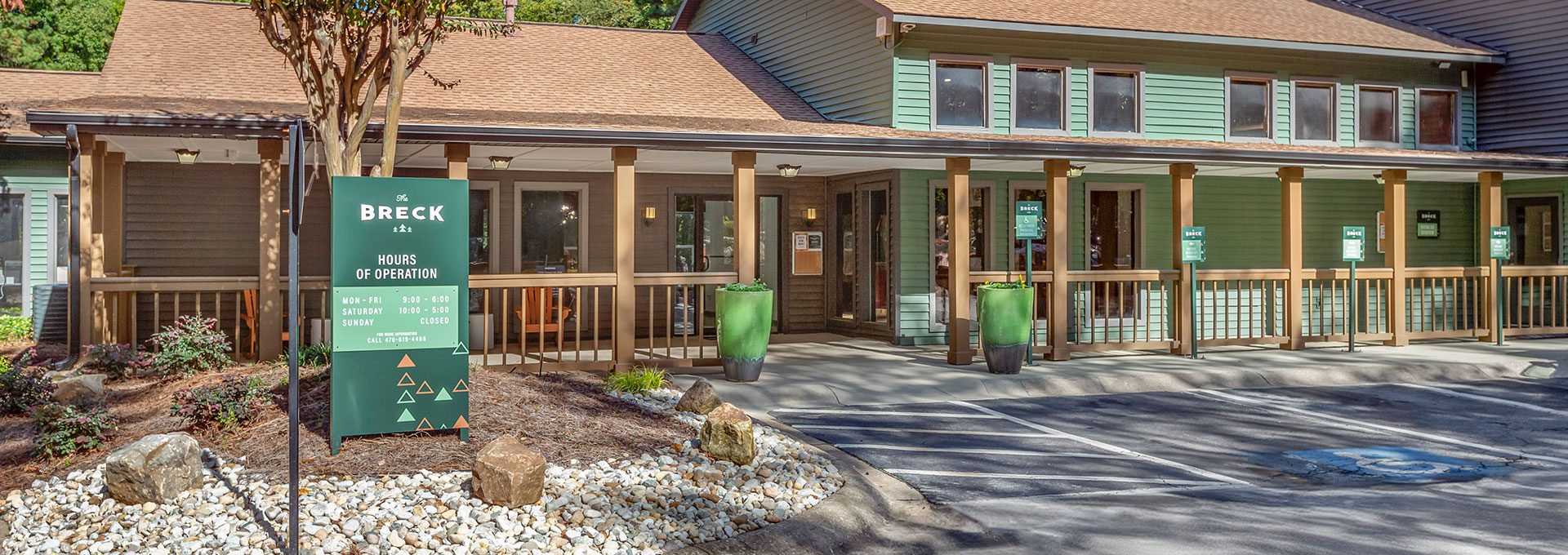 the front entrance to a building with a sign that says, welcome to the lodge at The  Breck