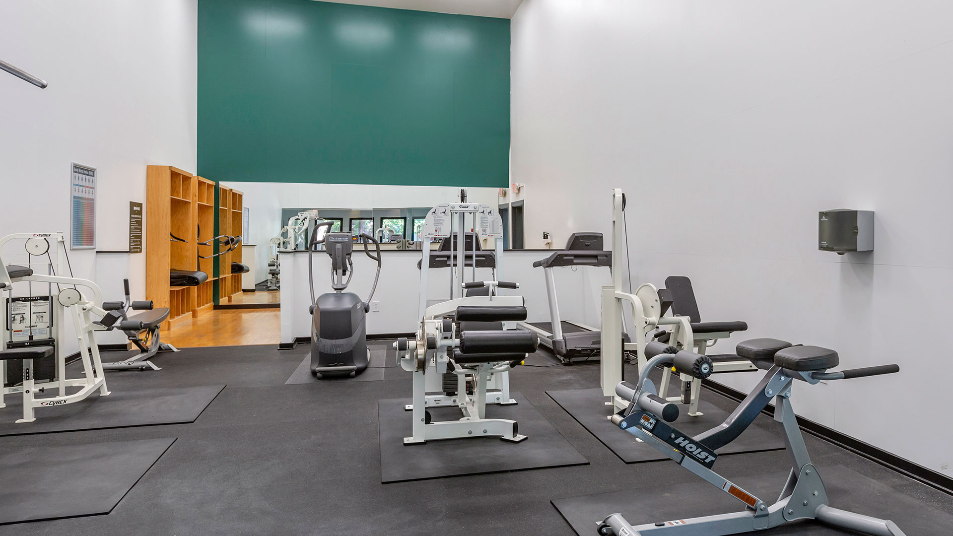 a gym room with equipment and mirrors on the wall at The  Breck