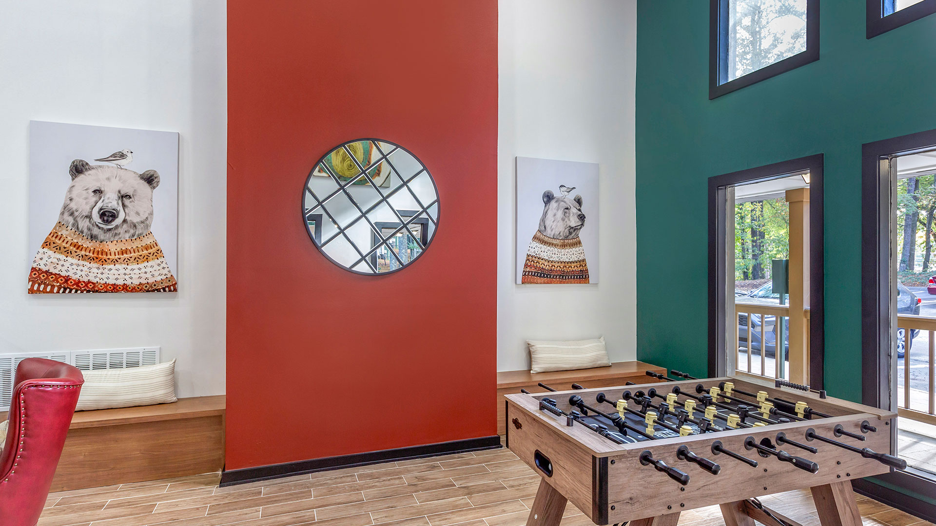 a foosball table in a living room with red walls at The  Breck