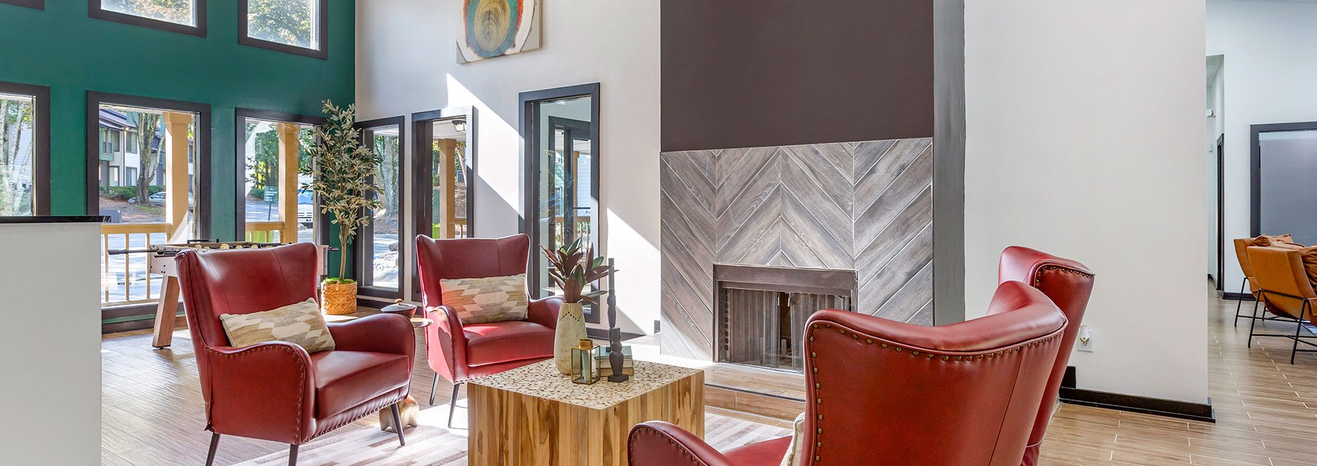 a living room with red chairs and a fireplace at The  Breck